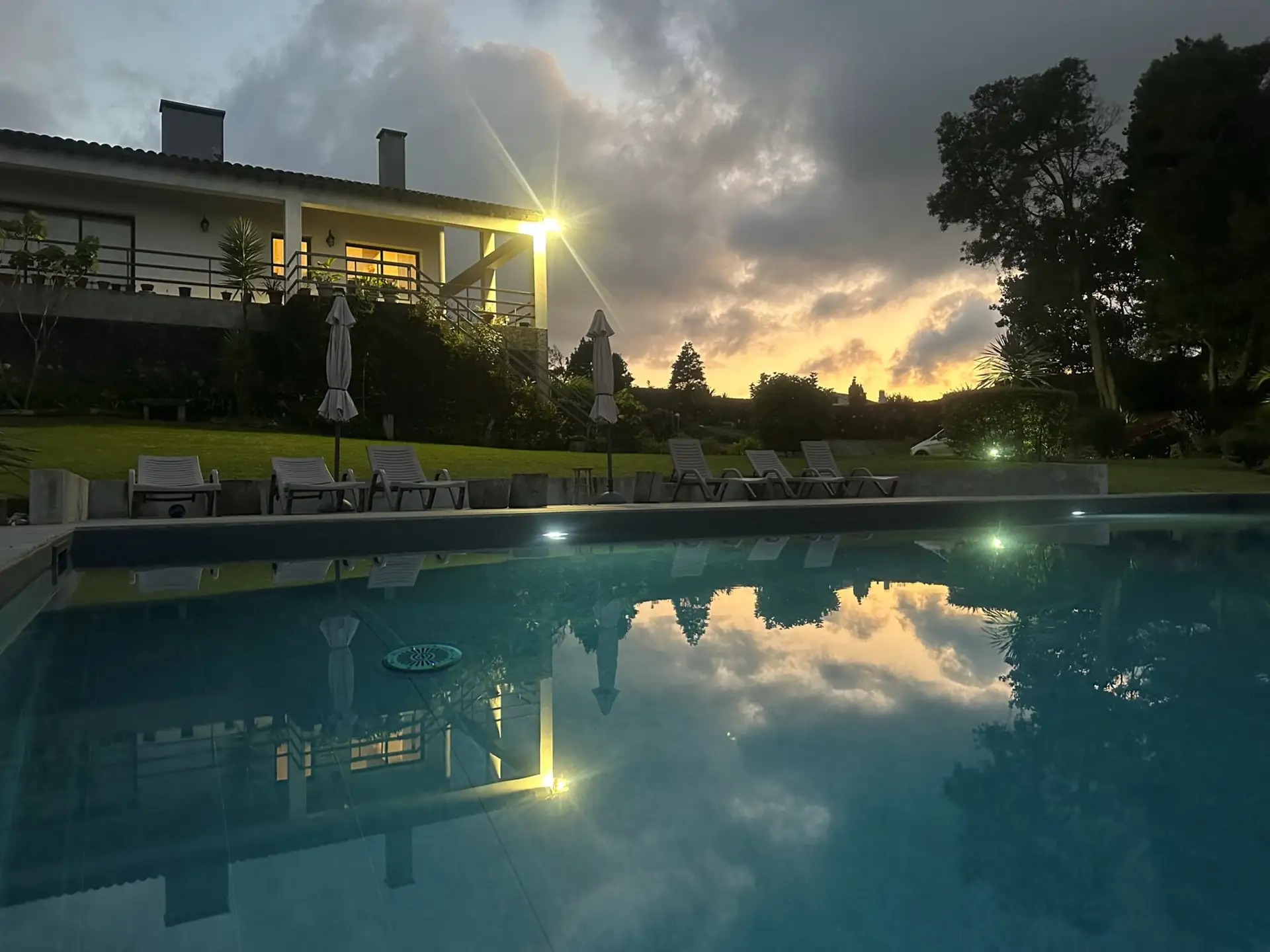 Swimming pool at dusk at Casa das Hotências