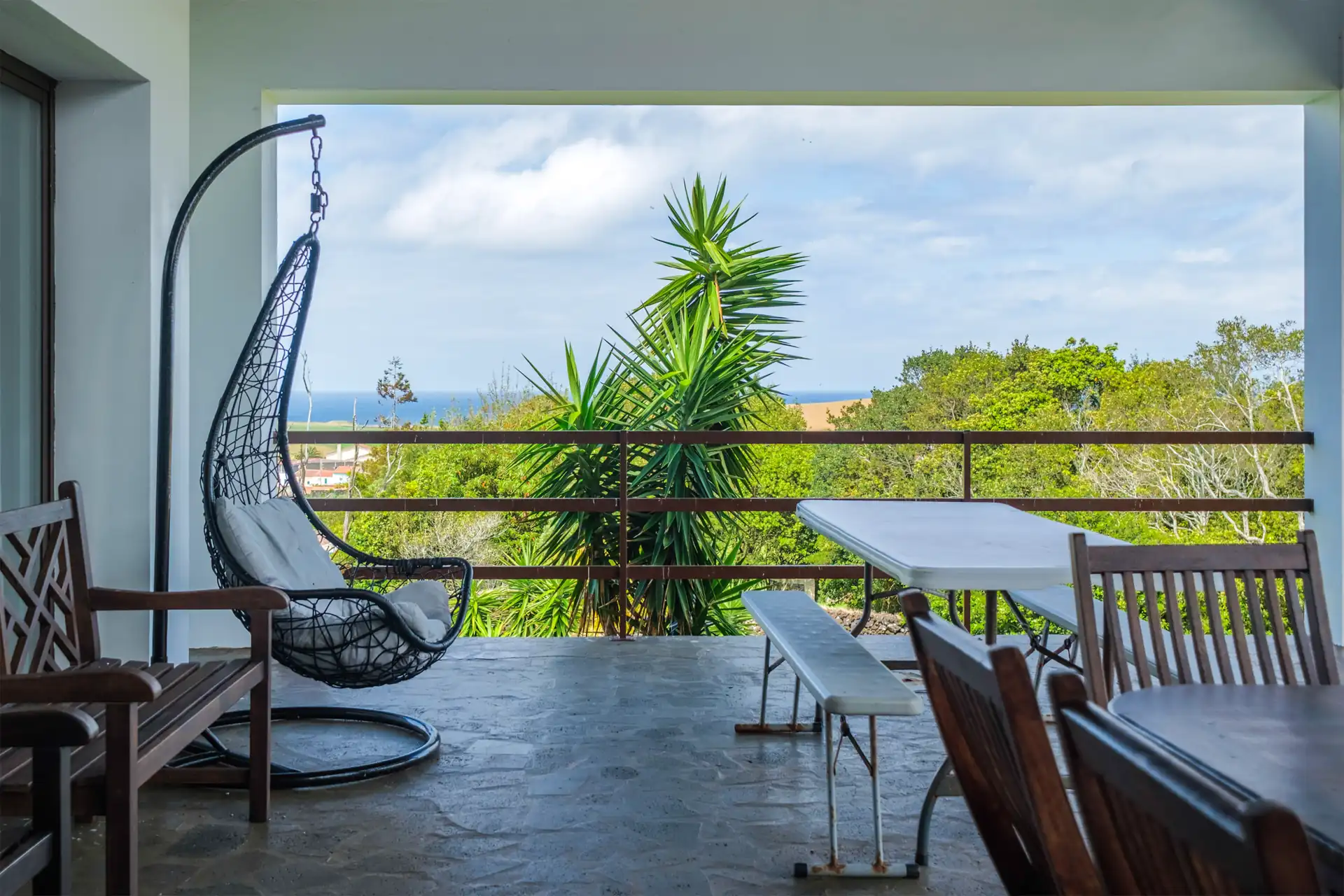 Hanging chair on the balcony overlooking the pool